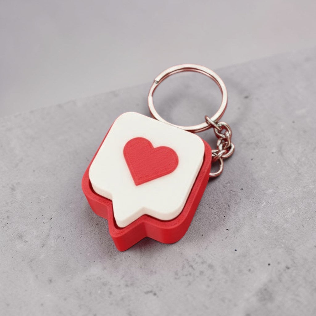 Red and white heart-shaped keychain on a wooden surface